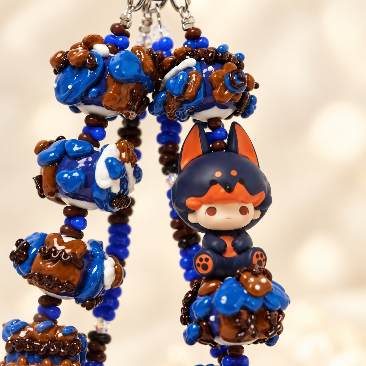 Close-up of DIMOO Pajama Doorbell Man character and decorative chunky beads