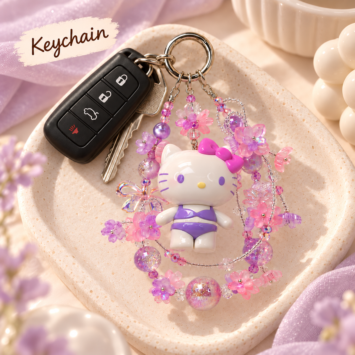 Hello Kitty glitter bead keychain styled with keys on a cream tray