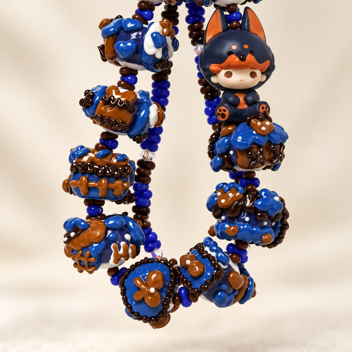 Blue and chocolate brown hand-decorated chunky bead details