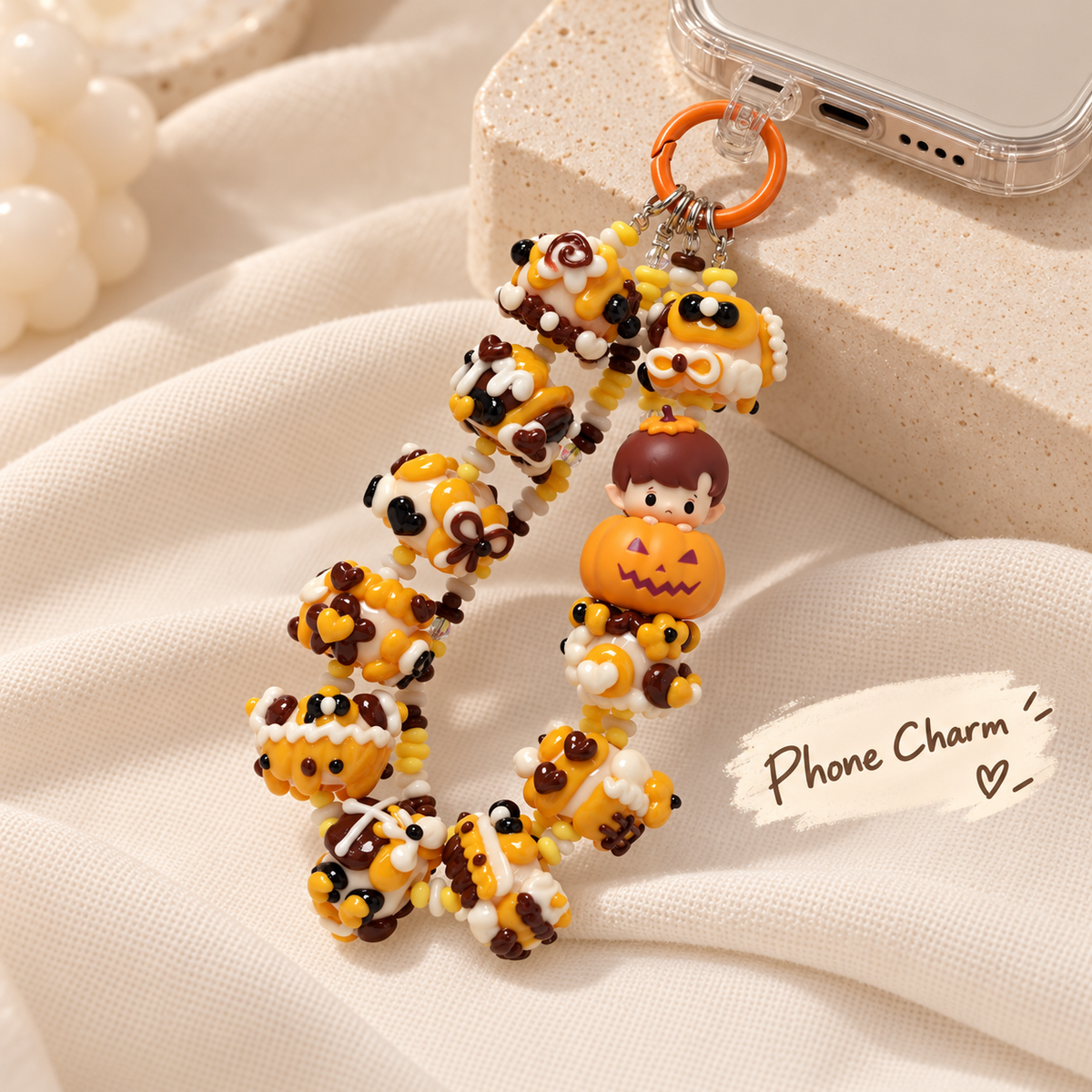 HACIPUPU pumpkin charm attached at the bottom of a clear phone case